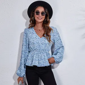 Elegant blue floral V-neck peplum blouse featuring stylish lantern sleeves for women