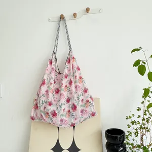 Close-up of a large capacity floral canvas tote bag in a lifestyle setting