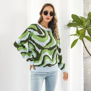 Detail of women's long sleeve sweater with green and blue wavy swirl pattern