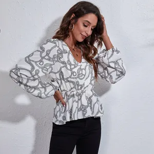 Elegant V-neck lantern sleeve peplum blouse featuring a black rope print on white fabric