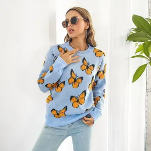 Detalle de suéter azul Y2K con llamativos diseños de mariposas amarillas en relieve
