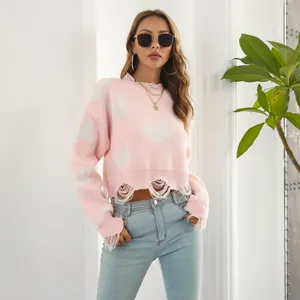 Detailed view of a pink Y2K cropped sweater with white butterfly jacquard and frayed hem
