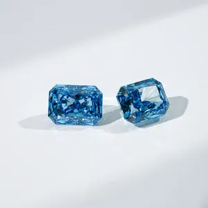 Macro view of two sparkling blue radiant cut lab grown diamonds on white surface