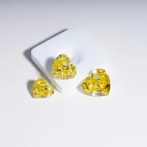 Macro view of heart-shaped yellow lab-grown diamonds showing brilliant vivid fire