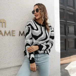 Close-up detail of a woman wearing a black and grey swirl pattern jacquard knit sweater.