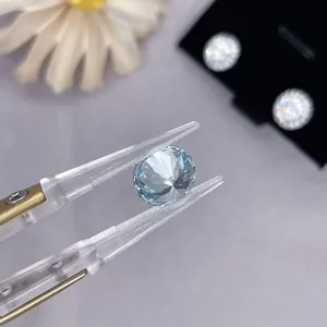Macro view of a brilliant round cut lab-grown blue diamond held by professional tweezers
