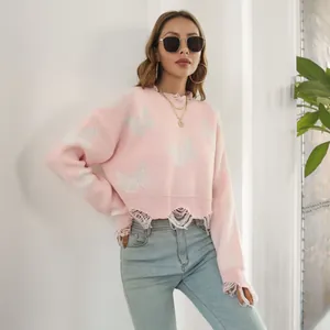 Y2K style pink butterfly jacquard cropped sweater with distressed ripped hem detail