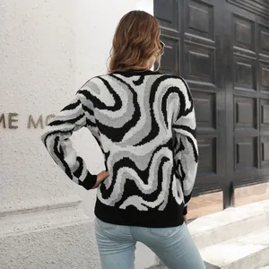 Detail view of a stylish black and white swirl patterned jacquard knit sweater for women.