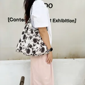 Detailed side view of a large capacity floral canvas tote bag perfect for beach vacation