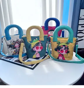 Detail view of colorful canvas bucket bags with cute hand-drawn girl illustrations
