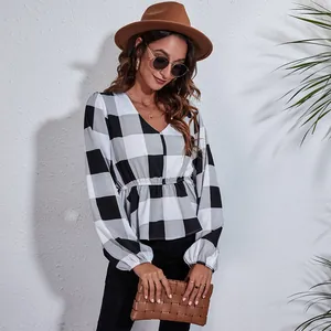 Stylish black and white plaid V-neck blouse with lantern sleeves and peplum waistline