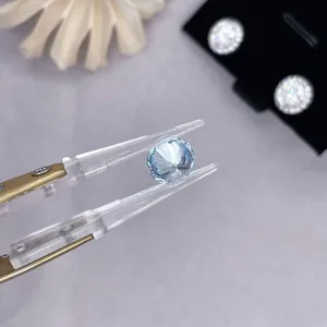 Round cut lab-grown light blue diamond loose gemstone held by professional tweezers