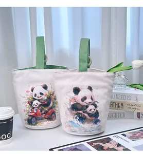 Detail view of two canvas bucket bags with cute panda prints in a lifestyle setting