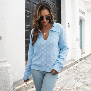 Primo piano dettagliato di un maglione azzurro con trama a scacchi 3D e colletto polo