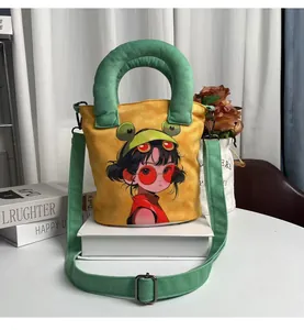 Hand-painted cartoon girl canvas bucket bag with green handles and crossbody strap