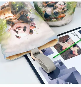 Close-up of canvas bucket bag featuring cute panda illustration and durable loop handle
