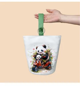 Close-up of a white canvas bucket bag featuring a cute panda riding a scooter design