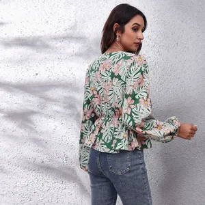 Back view detail of floral print lantern sleeve women's blouse with cinched waist.