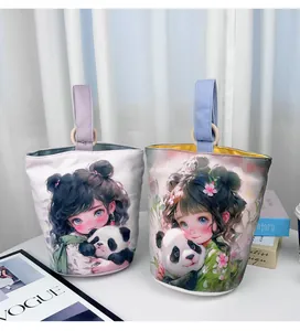 Detailed view of two canvas bucket bags featuring cute panda and girl illustrations.