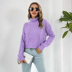 Model wearing a purple cropped cable-knit turtleneck sweater with a white bag