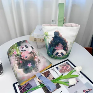 Fresh style canvas bucket bags featuring cute panda and girl illustrations on white table