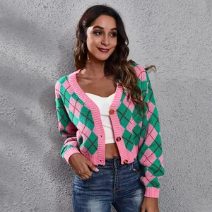 Close-up view of pink and green argyle cropped knit cardigan with button-up detail