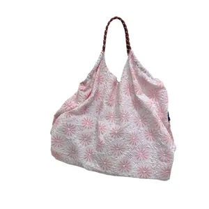 Élégant sac à main à fleurs MZTKIN avec motifs roses et une poignée tressée au design moderne