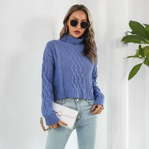 Close-up detail of the cable knit texture and turtleneck on this blue cropped sweater.
