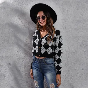 Women's black and white argyle jacquard knit cardigan shown in a stylish outdoor setting