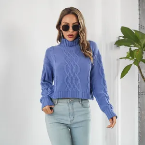 Detail of blue cable-knit turtleneck cropped sweater with oversized long sleeves