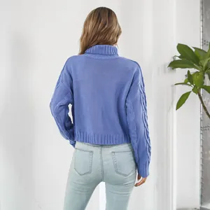 Back view detail of a blue cable-knit turtleneck cropped sweater with long sleeves