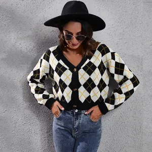 Stylish model wearing a black and white argyle knit cardigan against a textured wall