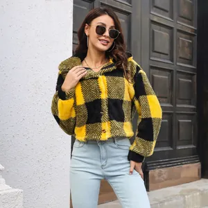 Close-up of yellow and black plaid fuzzy jacket with stylish lantern sleeves.