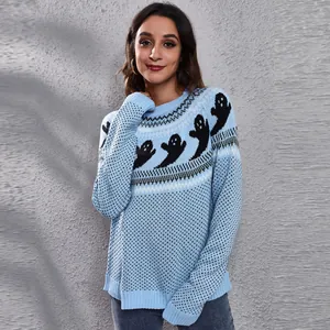 Detailed view of blue knit sweater with vintage black ghost and dot patterns for women.