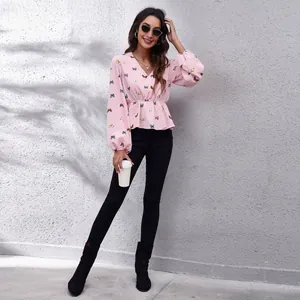 Stylish pink butterfly print blouse with V-neck and lantern sleeves for modern women