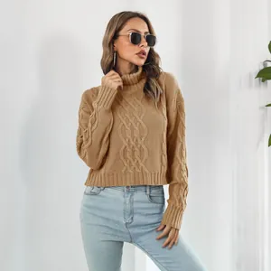 Close-up detail view of a khaki cable-knit turtleneck sweater with a cozy and loose fit.