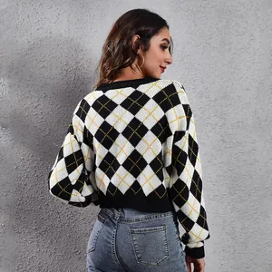 Back view of women's cropped argyle knit cardigan featuring a black and white pattern