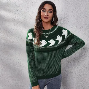 Close-up of the knit pattern on a green Halloween sweater featuring white ghosts and dots