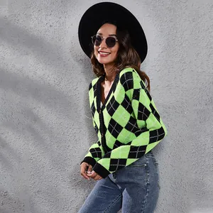 Close-up detail of green and black argyle pattern knitted cardigan sweater with V-neckline