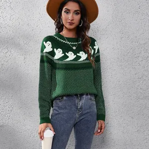 Close-up of green Halloween knit sweater with ghost patterns and white polka dots