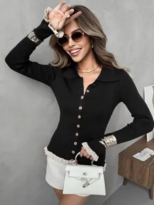Close-up of slim fit black ribbed knit top featuring ruffle cuffs and gold buttons