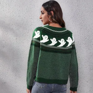 Back view detail of a green knitted sweater featuring white Halloween ghost patterns and dots