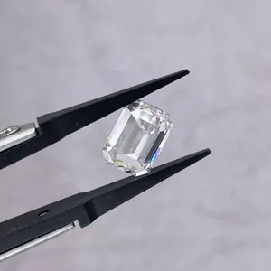 Close-up of 1 carat emerald cut D color VVS clarity lab-grown diamond in tweezers