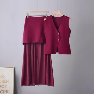 Detailed view of burgundy two-piece set featuring a knitted vest and pleated skirt