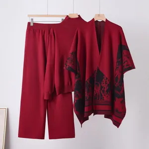 Elegant 3-piece red knit set with sweater, wide-leg pants and patterned shawl