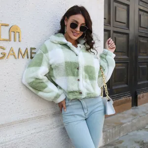 Close-up detail of a soft green and white checkered fuzzy jacket with lantern sleeves