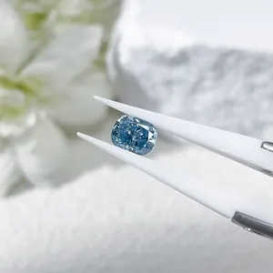 Exquisite cushion cut blue lab-grown diamond held by professional tweezers