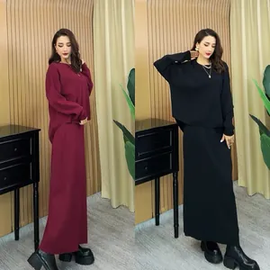 Elegant two-piece knit set featuring long sleeve sweater and maxi skirt in burgundy and black