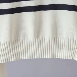 Close-up detail of a striped knit sweater showing high-quality ribbed hem and fabric texture