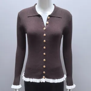 Close-up of a brown ribbed knit cardigan featuring white ruffles and golden buttons.